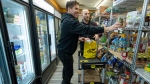 Ultra-fast grocery delivery company Ninja’s head of product Gonzalo Graham (front) and head of operations Michael Markevich pack an order at the company’s ghost store operation in Toronto on Tuesday, March 29, 2022. THE CANADIAN PRESS/Frank Gunn