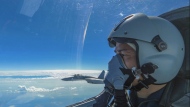 In this photo released by Xinhua News Agency, an air force pilot from the Eastern Theater Command of the Chinese People's Liberation Army (PLA) looks as they conduct a joint combat training exercises around the Taiwan Island on Sunday, Aug. 7, 2022. China said Monday it was extending threatening military exercises surrounding Taiwan that have disrupted shipping and air traffic and substantially raised concerns about the potential for conflict in a region crucial to global trade. (Wang Xinchao/Xinhua via AP)