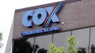 One of the buildings of the Cox Communications campus is surrounded by foliage in Atlanta on, Aug. 2, 2004. Cox Enterprises, which owns Cox Communications, is buying Axios Media for $525 million as it looks to grow and diversify its business. Cox, which became an investor in Axios last year, said Monday Aug. 8, 2022, that it will look to expand Axios into more cities, while having it cover more national topics and serve more premium niches for professionals. (AP Photo/Ric Feld, File)