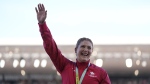 Sarah Mitton of Canada smiles on the podium after winning the gold medal in the Women's shot put during the athletics competition in the Alexander Stadium at the Commonwealth Games in Birmingham, England, Thursday, Aug. 4, 2022. (AP Photo/Alastair Grant)