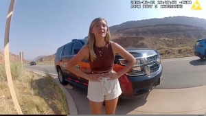 In this image taken from police body camera video provided by The Moab Police Department, Gabrielle 'Gabby' Petito talks to a police officer after police pulled over the van she was traveling in with her boyfriend, Brian Laundrie, near the entrance to Arches National Park on Aug. 12, 2021. (The Moab Police Department via AP, File)
