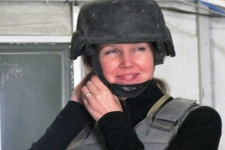 Calgary-based reporter Michelle Lang, 34, tries on her fragmentation vest and helmet at Kandahar Airfield on Sunday, Dec. 13, 2009. Lang was killed along with four Canadian soldiers by an improvised explosive device on Wednesday, Dec. 30, 2009, the first Canadian journalist killed in Afghanistan. (THE CANADIAN PRESS/ Colin Perkel)
