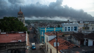 Smoke rises from a deadly fire at a large oil storage facility in Matanzas, Cuba, Tuesday, Aug. 9, 2022. The fire was triggered when lighting struck one of the facility's eight tanks late Friday, Aug. 5th. (AP Photo/Ismael Francisco)