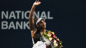 Serena Williams, of the USA, leaves the court carrying flowers and waving to fans after her defeat against Belinda Bencic, of Switzerland, during the National Bank Open tennis tournament in Toronto on Wednesday, August 10, 2022. THE CANADIAN PRESS/Chris Young