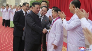 In this photo provided by the North Korean government, North Korean leader Kim Jong Un shakes hands with a health official in Pyongyang, North Korea, Wednesday, Aug. 10, 2022. Kim has declared victory over COVID-19 and ordered an easing of preventive measures. Independent journalists were not given access to cover the event depicted in this image distributed by the North Korean government. The content of this image is as provided and cannot be independently verified. Korean language watermark on image as provided by source reads: "KCNA" which is the abbreviation for Korean Central News Agency. (Korean Central News Agency/Korea News Service via AP)