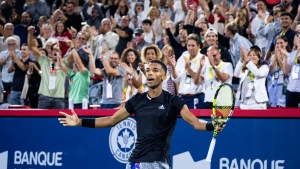 Canada's Felix Auger-Aliassime celebrates after winning the first set over Yoshihito Nishioka of Japan during second round of play at the National Bank Open tennis tournament Wednesday August 10, 2022 in Montreal. THE CANADIAN PRESS/Paul Chiasson