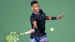 Canada's Felix Auger-Aliassime returns to Cameron Norrie of Great Britain during round of sixteen play at the National Bank Open tennis tournament, Thursday, August 11, 2022 in Montreal. THE CANADIAN PRESS/Paul Chiasson