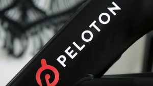 FILE - A Peloton logo is seen on the company's stationary bicycle on Nov. 19, 2019, in San Francisco. Peloton is laying off employees and raising prices for some of its equipment as part of its latest bid to make the business profitable and free up cash, according to a memo disclosed to employees on Friday, Aug. 12, 2022. (AP Photo/Jeff Chiu, File)