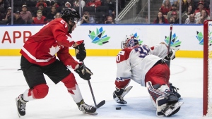 Canada's Mason McTavish (23) scores a goal against Czechia's goalie Tomas Suchanek (30) during second period IIHF World Junior Hockey Championship action in Edmonton on Saturday August 13, 2022. THE CANADIAN PRESS/Jason Franson