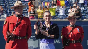 Simona Halep, of Romania, poses with the trophy after defeating Beatriz Haddad Maia, of Brazil, in National Bank Open final tennis tournament in Toronto on Sunday, August 14, 2022. THE CANADIAN PRESS/Nathan Denette