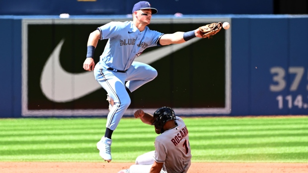 Toronto Blue Jays third baseman Matt Chapman is unable to make a catch to put out Cleveland Guardians' Amed Rosario with a successful stolen base batter in third inning American League baseball action in Toronto on Sunday, August 14, 2022. THE CANADIAN PRESS/Jon Blacker