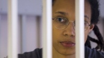FILE - US Basketball player Brittney Griner looks through bars as she listens to the verdict standing in a cage in a courtroom in Khimki, outside Moscow, Russia, Thursday, Aug. 4, 2022. Lawyers for American basketball star Brittney Griner on Monday, Aug. 15, 2022 filed an appeal of her nine-year Russian prison sentence for drugs possession. Griner, a center for the Phoenix Mercury and a two-time Olympic gold medalist, was convicted on Aug. 4. She was arrested in February at Moscow's Sheremetyevo Airport after vape canisters containing cannabis oil were found in her luggage. (Evgenia Novozhenina/Pool Photo via AP, File)