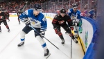 Canada's Jack Thompson (22) and Finland's Aatu Raty (34) and Roni Hirvonen (22) battle for the puck during third period IIHF World Junior Hockey Championship action in Edmonton on Monday August 15, 2022. THE CANADIAN PRESS/Jason Franson