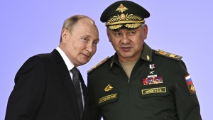 Russia's President Vladimir Putin and Russian Defense Minister Sergei Shoigu attend the opening of the Army 2022 International Military and Technical Forum in the Patriot Park outside Moscow, Russia, Monday, Aug. 15, 2022. Putin vowed to strengthen Russia's military cooperation with its allies. (Sputnik, Kremlin Pool Photo via AP)
