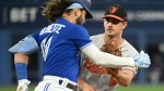 Baltimore Orioles starting pitcher Dean Kremer, right, tags out Toronto Blue Jays' Bo Bichette after fielding a slow ground ball in fourth inning American League baseball action in Toronto on Tuesday, August 16, 2022. THE CANADIAN PRESS/Jon Blacker