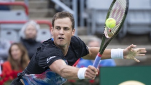 Canada's Vasek Pospisil returns to Tommy Paul of the United States during first round action at the National Bank Open tennis tournament Tuesday August 9, 2022 in Montreal. THE CANADIAN PRESS/Paul Chiasson