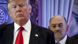FILE - Allen Weisselberg, right, stands behind then President-elect Donald Trump during a news conference in the lobby of Trump Tower in New York, Jan. 11, 2017. Weisselberg, Trump's chief financial officer, is expected to plead guilty on Thursday, Aug. 18, 2022 to tax violations in a deal that would require him to testify about business practices at the former president's company. (AP Photo/Evan Vucci, File)