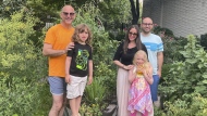 This Aug. 12, 2022, photo shows, from left, Garden sitter Jono Waks, left, with Lev Guttenberg, from second left, Tal Guttenberg, Zoe Guttenberg and Doug Guttenberg at the Scholes Street Children’s Garden in the Brooklyn borough of New York. The Guttenberg family leaves the care of their community plot and backyard garden to their neighbor, Waks, when they spend a month at their Detroit home each summer. (Jono Waks via AP).