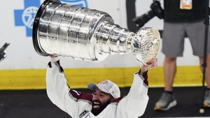 Colorado Avalanche center Nazem Kadri lifts the Stanley Cup after the team defeated the Tampa Bay Lightning 2-1 in Game 6 of the NHL hockey Stanley Cup Finals on Sunday, June 26, 2022, in Tampa, Fla. THE CANADIAN PRESS/AP-John Bazemore