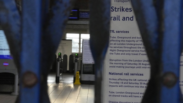 The gates at Northfields tube station are closed as members of the Rail, Maritime and Transport union (RMT) continue nationwide strikes in a bitter dispute over pay, jobs and conditions in London, Friday, Aug. 19, 2022.(AP Photo/Frank Augstein)