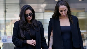 Vanessa Bryant, left, the widow of the late Kobe Bryant, holds hands with friend, Sydney Leroux as they leave a federal courthouse in Los Angeles Friday, Aug. 19, 2022. Vanessa Bryant testified Friday that she was only beginning to grieve the loss of her husband, basketball star Kobe Bryant, and their 13-year-old daughter Gianna when she was faced with the fresh horror of learning that sheriff's deputies and firefighters had shot and shared photos of their bodies at the site of the helicopter crash that killed them. (AP Photo/Damian Dovarganes)