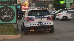 A Toronto police cruiser is seen at the scene of a robbery and shooting in Scarborough.