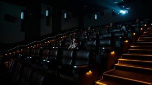 FILE - Movie goers sit in a theatre at a Cineplex in Toronto, on Tuesday, October 6, 2020. THE CANADIAN PRESS/Chris Young 