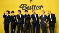 FILE- Members of South Korean K-pop band BTS, V, SUGA, JIN, Jung Kook, RM, Jimin, and j-hope from left to right, pose for photographers ahead of a press conference to introduce their new single "Butter" in Seoul, South Korea, Friday, May 21, 2021. South Korea may conduct a public survey to help determine whether to grant exemptions of the mandatory military service to members of the K-pop superstar boyband BTS, officials said Wednesday, Aug. 31, 2022.(AP Photo/Lee Jin-man, File)