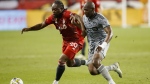 Toronto FC forward Ayo Akinola (20) and CF Montreal defender Rudy Camacho (4) run for the ball during first half MLS soccer action in Toronto on Sunday, Sept. 4, 2022. THE CANADIAN PRESS/Cole Burston
