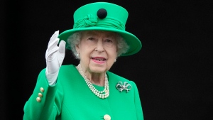 Queen Elizabeth II waves to the crowd during the Platinum Jubilee Pageant at the Buckingham Palace in London, Sunday, June 5, 2022, on the last of four days of celebrations to mark the Platinum Jubilee.  (AP Photo/Frank Augstein, File)
