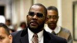 Musician R. Kelly, center, leaves the Daley Center after a hearing in his child support case on May 8, 2019, in Chicago. (AP Photo/Matt Marton, File)