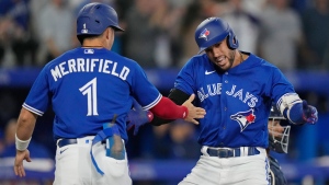 Toronto Blue Jays' George Springer (right) celebrates his two-run home run against the Tampa Bay Rays with teammate Whit Merrifield (1) during seventh inning MLB action in Toronto, Tuesday, Sept. 13, 2022. THE CANADIAN PRESS/Frank Gunn