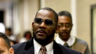 FILE - Musician R. Kelly, center, leaves the Daley Center after a hearing in his child support case on May 8, 2019, in Chicago. Closing arguments are scheduled Monday, Sept. 12, 2022 for R. Kelly and two co-defendants in the R&B singer’s trial on federal charges of trial-fixing, child pornography and enticing minors for sex, with jury deliberations to follow. (AP Photo/Matt Marton, File)