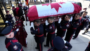 The casket of Const. Andrew Hong is carried into the Toronto Congress Centre during his funeral in Toronto on Wednesday, Sept. 21, 2022. Const. Hong was shot dead last week while on break during a training session in what police are calling an ambush attack. THE CANADIAN PRESS/Frank Gunn
