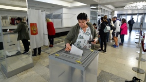 People from Luhansk and Donetsk regions, the territory controlled by a pro-Russia separatist governments, who live in Crimea, vote during a referendum in Sevastopol, Crimea, Friday, Sept. 23, 2022. Voting began Friday in four Moscow-held regions of Ukraine on referendums to become part of Russia. Polls also opened in Russia, where refugees from regions under Russian control can cast their votes. (AP Photo)