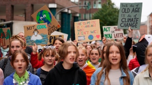 Protesters hold placards during a Fridays For Future (FFF) demonstration in Hamburg, Germany, Friday, Sept. 23, 2022. Youth activists staged a coordinated â€œglobal climate strikeâ€ on Friday to highlight their fears about the effects of global warming and demand more aid for poor countries hit by wild weather. (Marcus Brandt/dpa via AP)