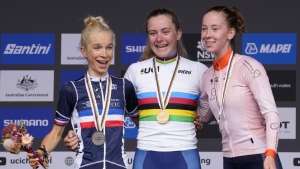 Britain's Zoe Backstedt, center, celebrates with the other medal winners, Eglantine Rayer of France, left, and Nienke Vinke of Netherlands from the junior women's road race at the world road cycling championships in Wollongong, Australia, Saturday, Sept. 24, 2022. Backstedt won gold, Rayer silver, and Vinke took the bronze. (AP Photo/Rick Rycroft)