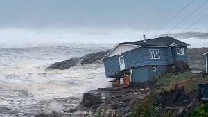 In this photo provided by Wreckhouse Press a home fights against high winds caused by post Tropical Storm Fiona in Port aux Basques, Newfoundland and Labrador, Saturday, Sept. 24, 2022. The home has since been lost at sea. (Rene Roy/Wreckhouse Press via The Canadian Press via AP)