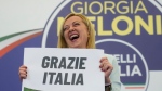 Far-Right party Brothers of Italy's leader Giorgia Meloni shows a placard reading in Italian "Thank you Italy" at her party's electoral headquarters in Rome, Sunday, Sept. 25, 2022. Italians voted in a national election that might yield the nation's first government led by the far right since the end of World War II. (AP Photo/Gregorio Borgia)