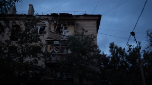 An apartment building damaged after a Russian attack is seen during the dusk in Kramatorsk, Ukraine, Monday, Sept. 26, 2022. (AP Photo/Leo Correa)