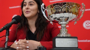 The Lou Marsh Trophy is seen in the foreground as Bianca Andreescu speaks to reporters during a media availability in Toronto, Tuesday, Dec. 10, 2019. The trophy, which has been handed to the country's top athlete, male or female, annually since 1936, is getting a new name. THE CANADIAN PRESS/Hans Deryk