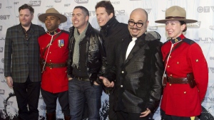 The Barenaked Ladies pose with two Mounties on the red carpet at the 2011 JUNO Awards in Toronto on Sunday, March 27, 2011. The Barenaked Ladies are planning a Canadian tour for December where they'll play selections from their Christmas-themed album. THE CANADIAN PRESS/Chris Young