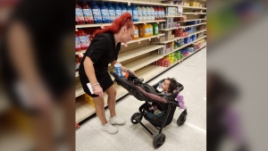 This undated photo provided by Deatrie Young shows Jazmin Valentine and her baby at a supermarket. Valentine filed a federal lawsuit Tuesday, Sept. 27, 2022, alleging that nurses and staff at the Washington County jail in Maryland ignored her screams and plea for help as she gave birth to her daughter there in July 2021. (Deatrie Young via AP)