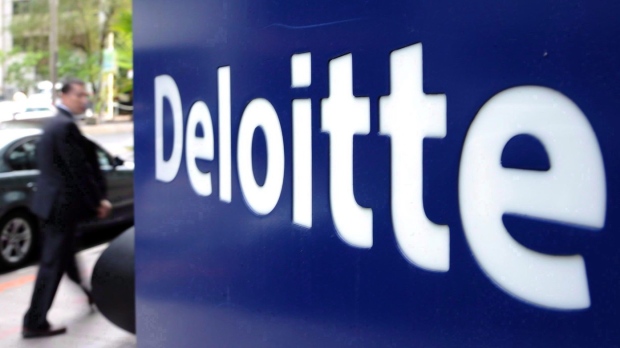 A pedestrian walks past a Deloitte sign in downtown Ottawa on Tuesday, Sept. 20, 2011. A tight labour market and elevated savings during the pandemic will cushion the impact of a recession on Canadians, says a new report from Deloitte. THE CANADIAN PRESS/Sean Kilpatrick