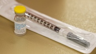 A vial containing the monkeypox vaccine and a syringe is set on the table at a vaccination clinic run by the Mecklenburg County Public Health Department in Charlotte, N.C., Saturday, Aug. 20, 2022. At-risk people who received just one dose of the monkeypox vaccine appeared to be significantly less likely to get sick from the virus, public health officials announced Wednesday, even as they urged a second dose for full protection. (AP Photo/Nell Redmond, File)