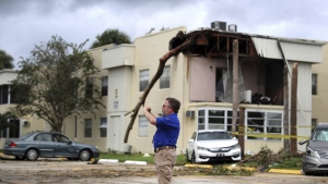 David Dellinger with the National Weather Service, surveys the damage from an apparent overnight tornado spawned from Hurricane Ian at Kings Point 55+ community in Delray Beach, Fla., on Wednesday, Sept. 28, 2022. (Carline Jean /South Florida Sun-Sentinel via AP)