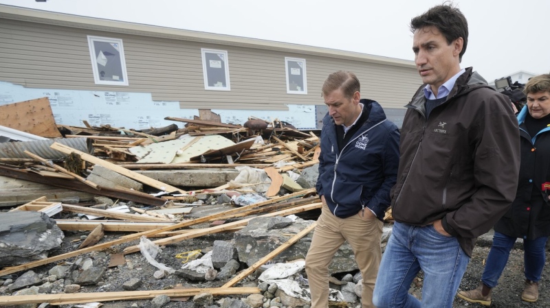 Prime Minister Justin Trudeau, right, and Newfoundland and Labrador Premier Andrew Furey tour the damage cause by post-tropical storm Fiona in Port aux Basques, N.L. on Wednesday, Sept. 28, 2022. THE CANADIAN PRESS/Frank Gunn
