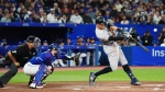 New York Yankees designated hitter Aaron Judge (99) flies out to right field as Toronto Blue Jays catcher Danny Jansen (9) looks on during second inning American League MLB baseball action in Toronto on Wednesday, September 28, 2022. THE CANADIAN PRESS/Nathan Denette