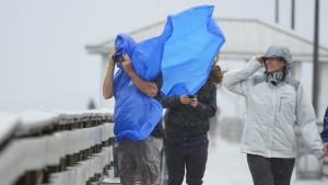 People walk on the Ballast Point Pier ahead of Hurricane Ian, Wednesday, Sept. 28, 2022, in Tampa, Fla. The U.S. National Hurricane Center says Ian's most damaging winds have begun hitting Florida's southwest coast as the storm approaches landfall. THE CANADIAN PRESS/AP-Chris O'Meara