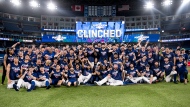 The Toronto Blue Jays and team personnel celebrates clinching a playoff spot after defeating the Boston Red Sox in AL MLB baseball action in Toronto on Friday, September 30, 2022. THE CANADIAN PRESS/Christopher Katsarov